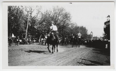 Men riding horses on Main Street, Russellville, Ark.
