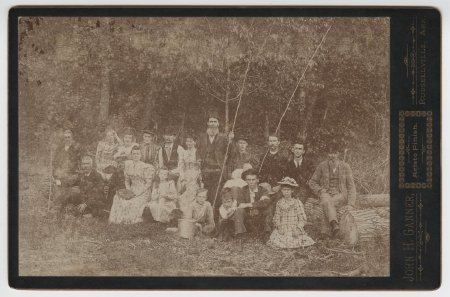 Group of 18 people sitting on logs